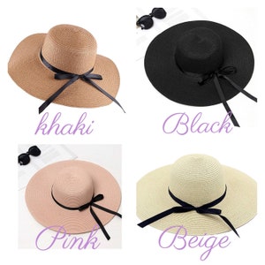 May include: Four wide-brimmed straw sun hats with black ribbon ties. The hats are in the colors khaki, black, pink, and beige.