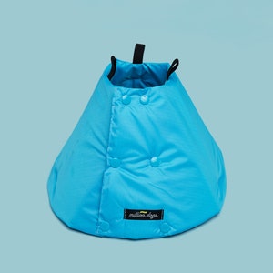 May include: A bright blue dog cone with a black strap and a white label that says "million dogs".