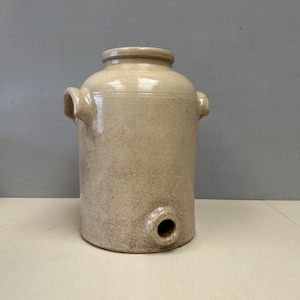 May include: A white ceramic crock with two handles and a spout. The crock has a speckled glaze and is in good condition.