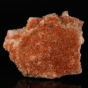 May include: A cluster of orange-brown crystals with a rough, textured surface. The crystals are densely packed together, creating a visually interesting and unique specimen.