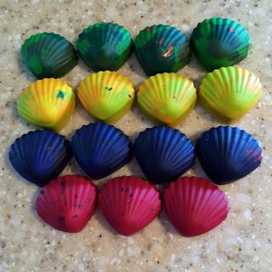 May include: A set of 12 colorful seashell-shaped crayons in shades of green, yellow, blue, and red.