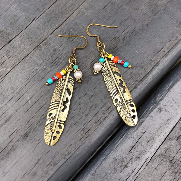 Gold tribal feather with mini turquoise, red, orange, yellow, and white pearl bead earrings