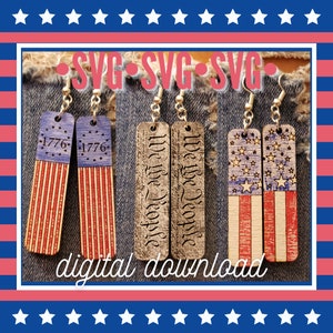 May include: Three pairs of wooden earrings with patriotic designs. The first pair features the year 1776 on each earring with a red, white, and blue American flag design. The second pair features the words "We the People" on each earring. The third pair features a red, white, and blue American flag design with stars on each earring.
