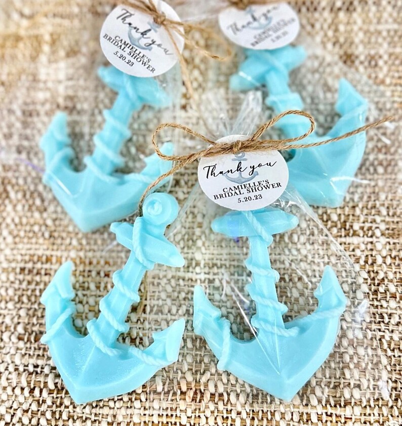 May include: Thank you favor bags with blue anchor shaped soaps and a round tag that says "Thank you Camille's Bridal Shower 5.20.23"