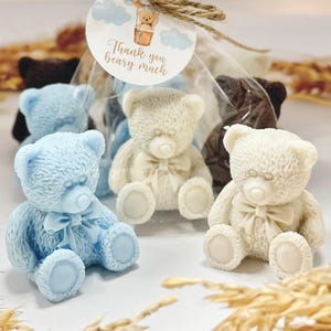 May include: Four small teddy bear shaped soaps, two are white, one is light blue, and one is brown. The soaps are packaged in clear cellophane bags with a small tag that says "Thank you beary much".