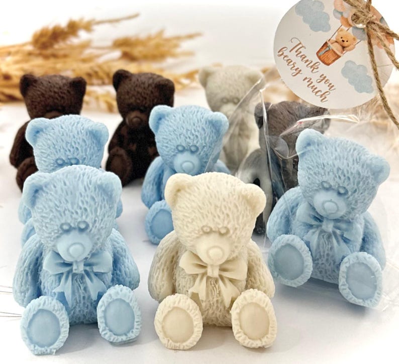 May include: Assortment of small teddy bear shaped soaps in blue, brown, and white. The soaps are packaged in clear cellophane bags with a thank you tag that says "Thank you bear-y much".