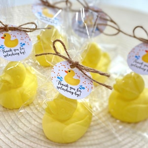 May include: Yellow rubber duck bath toys wrapped in clear cellophane bags with a brown twine bow and a round tag that says "Thank you for splashing by!" with a yellow rubber duck and blue raindrops on it.