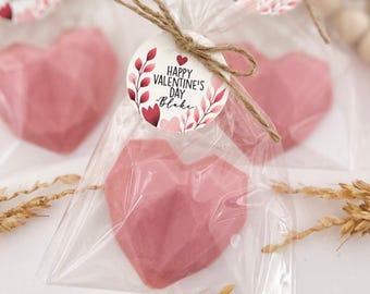 May include: Pink heart-shaped favors in clear cellophane bags tied with twine and a round tag that says "Happy Valentine's Day - Blake".