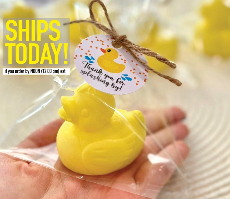 May include: Yellow rubber ducky favor in a clear plastic bag with a white circle tag that says "Thank you for splashing by!" with orange polka dots and blue raindrops.