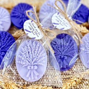 May include: Lavender-scented soap bars wrapped in clear cellophane bags with a lavender-themed tag that reads "Thank you for showering Olivia with love!"