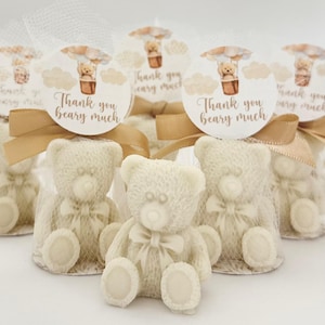 May include: Set of small white teddy bear favors with a brown ribbon and a round tag that says "Thank you beary much" with a hot air balloon illustration.