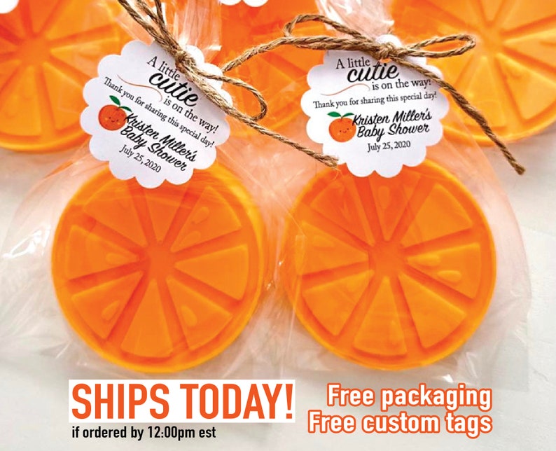 May include: Orange-shaped soap favors with a cute orange graphic and a tag that reads "A little cutie is on the way! Thank you for sharing this special day! Kristen Miller's Baby Shower July 25, 2020"