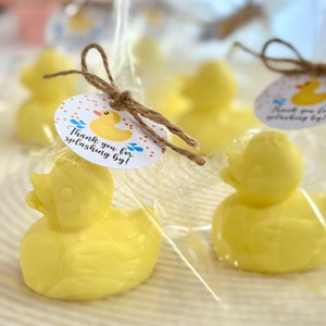 May include: Yellow rubber ducky favors wrapped in clear cellophane bags with a brown twine bow and a round tag that says "Thank you for splashing by!"