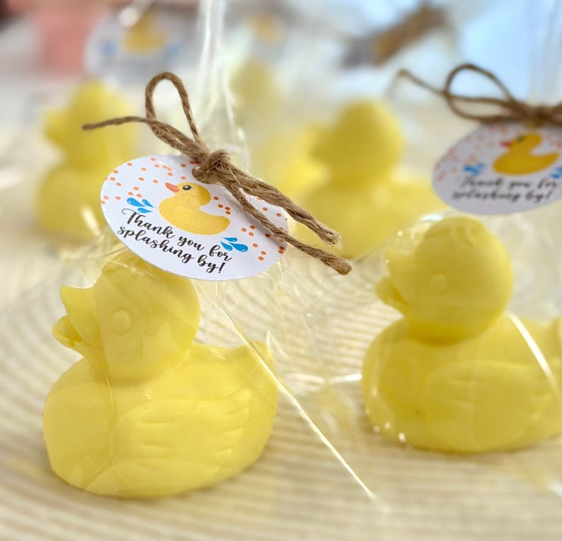 May include: Yellow rubber ducky favors wrapped in clear cellophane bags with a brown twine bow and a round tag that says "Thank you for splashing by!"