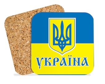 May include: A yellow and blue square coaster with the Ukrainian coat of arms and the word "Україна" in Cyrillic script.