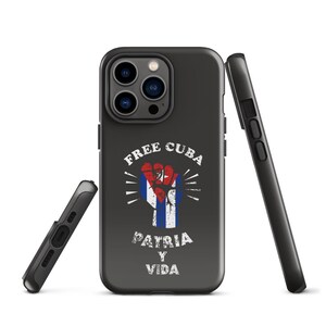 May include: Black iPhone case with a raised fist design. The fist is holding a Cuban flag and the text "Free Cuba Patria y Vida" is printed below the fist.