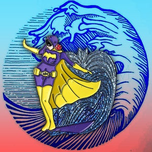 May include: A purple and yellow enamel pin featuring a stylized Batgirl character. The pin has a yellow cape and boots, with a bat symbol on the chest. The background includes a blue wave design.