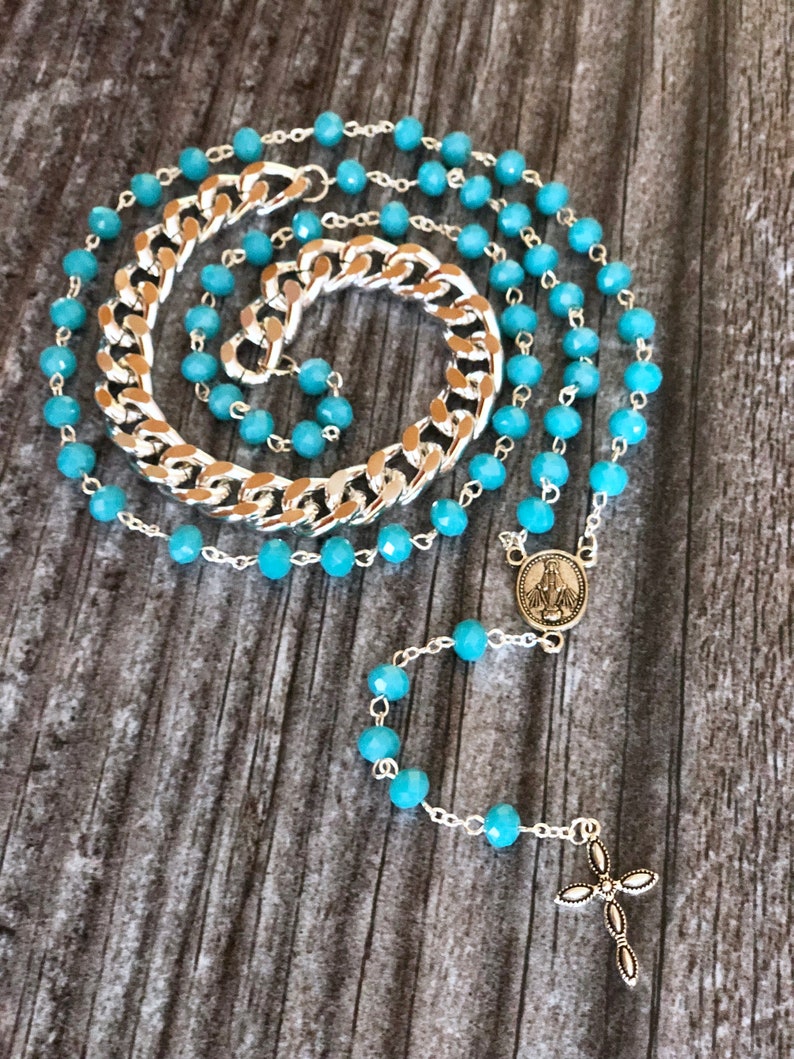 Light blue rosary style necklace with crystal beads and chain.