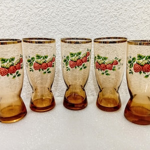 May include: A set of three ceramic mugs with a speckled, matte finish. The mugs are in shades of cream, light gray, and dark gray. Each mug has a simple, minimalist design and a rounded handle.