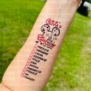 May include: A red and black temporary tattoo with a Mickey Mouse head and the text "Olivia's Birthday Around the World". The tattoo also includes a list of countries with checkboxes next to them, including Mexico, Norway, China, Germany, Italy, USA, Japan, Morocco, France, UK, and Canada.