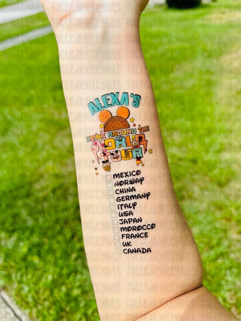 May include: A temporary tattoo with the text "Alexa's Drink Around the World Tour" and a list of countries including Mexico, Norway, China, Germany, Italy, USA, Japan, Morocco, France, UK, and Canada.