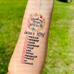 May include: A temporary tattoo with a circle of colorful drink icons and the text "Drinking Around the World" and "Jason's 30th!" with a checklist of countries to mark off.