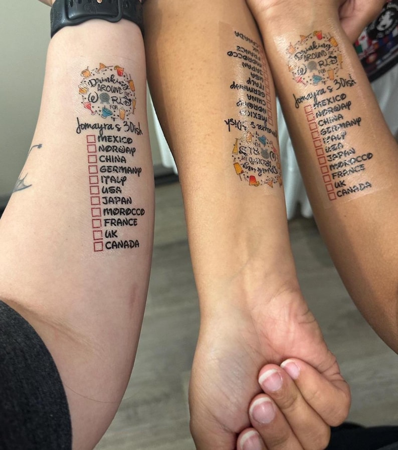 May include: Two people's arms with temporary tattoos that say "Drinking Around the World" with a list of countries and checkboxes next to each country.