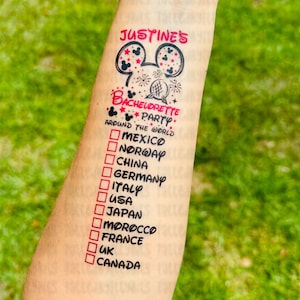 May include: A temporary tattoo with a Mickey Mouse head design and the text "JUSTINE'S BACHELORETTE PARTY AROUND THE WORLD" with a checklist of countries to visit, including Mexico, Norway, China, Germany, Italy, USA, Japan, Morocco, France, UK, and Canada.
