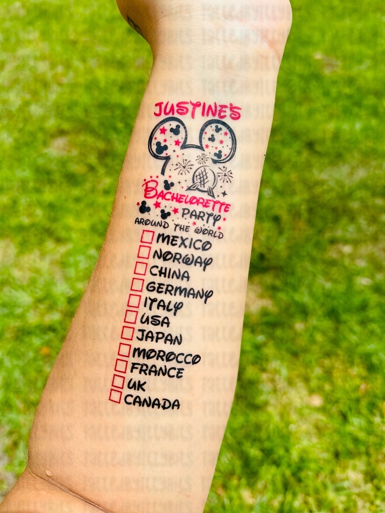 May include: A temporary tattoo with a Mickey Mouse head design and the text "JUSTINE'S BACHELORETTE PARTY AROUND THE WORLD" with a checklist of countries to visit, including Mexico, Norway, China, Germany, Italy, USA, Japan, Morocco, France, UK, and Canada.