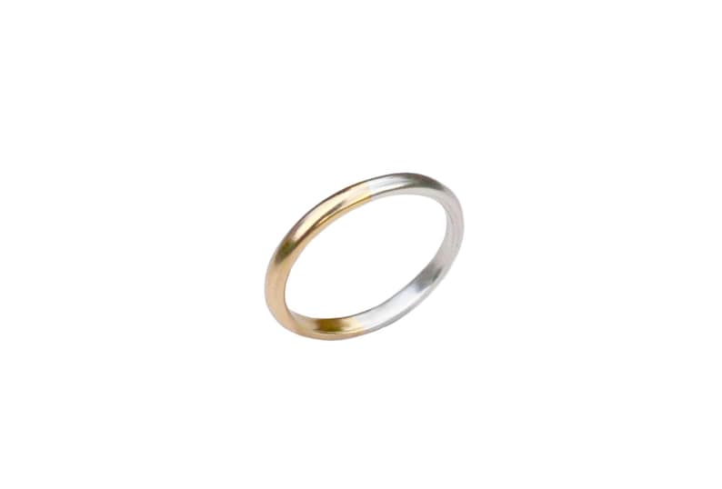 May include: A simple gold and silver wedding band. The band is made of two metals, with the gold on the outside and the silver on the inside.