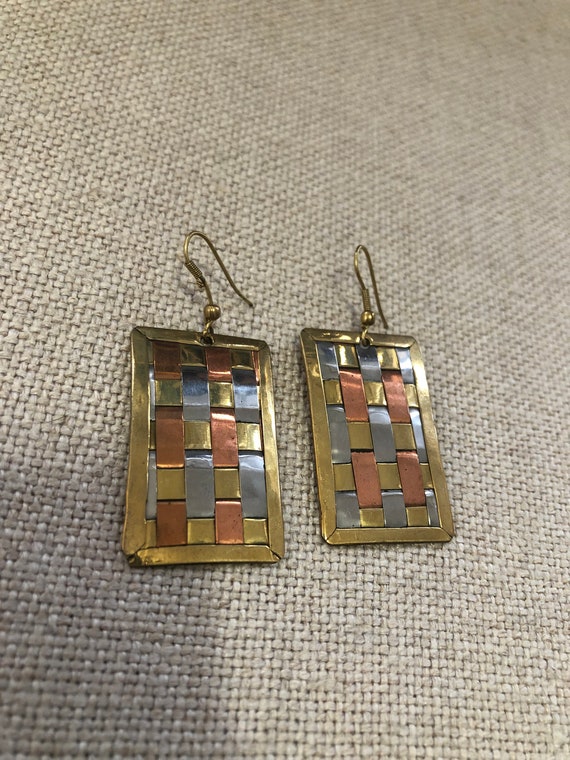 Pair of long Gamble gilded metal earrings holding two …