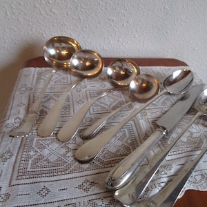 Silver plated serving utensils. Ladles, serving spoon, carving knife. Vintage midcentury price per piece in various sizes.