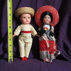 1950s Mexican fiesta doll pair 9 inches. Good condition w traditional costumes. Composition male and plastic female with moving arms.