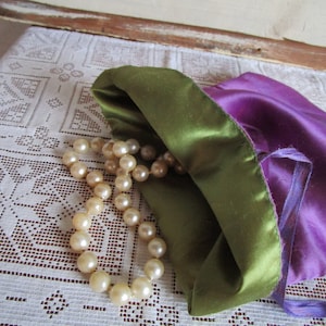 Purple lingerie pouch, travel bag lined in green with tie ribbons. Fold-over bag with one large pouch. Vintage mid-century.