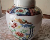 Miyako ginger jar handcrafted porcelain Imari Ware Japan. Red chrysanthemum and blue bamboo design w geometric borders. Midcentury.