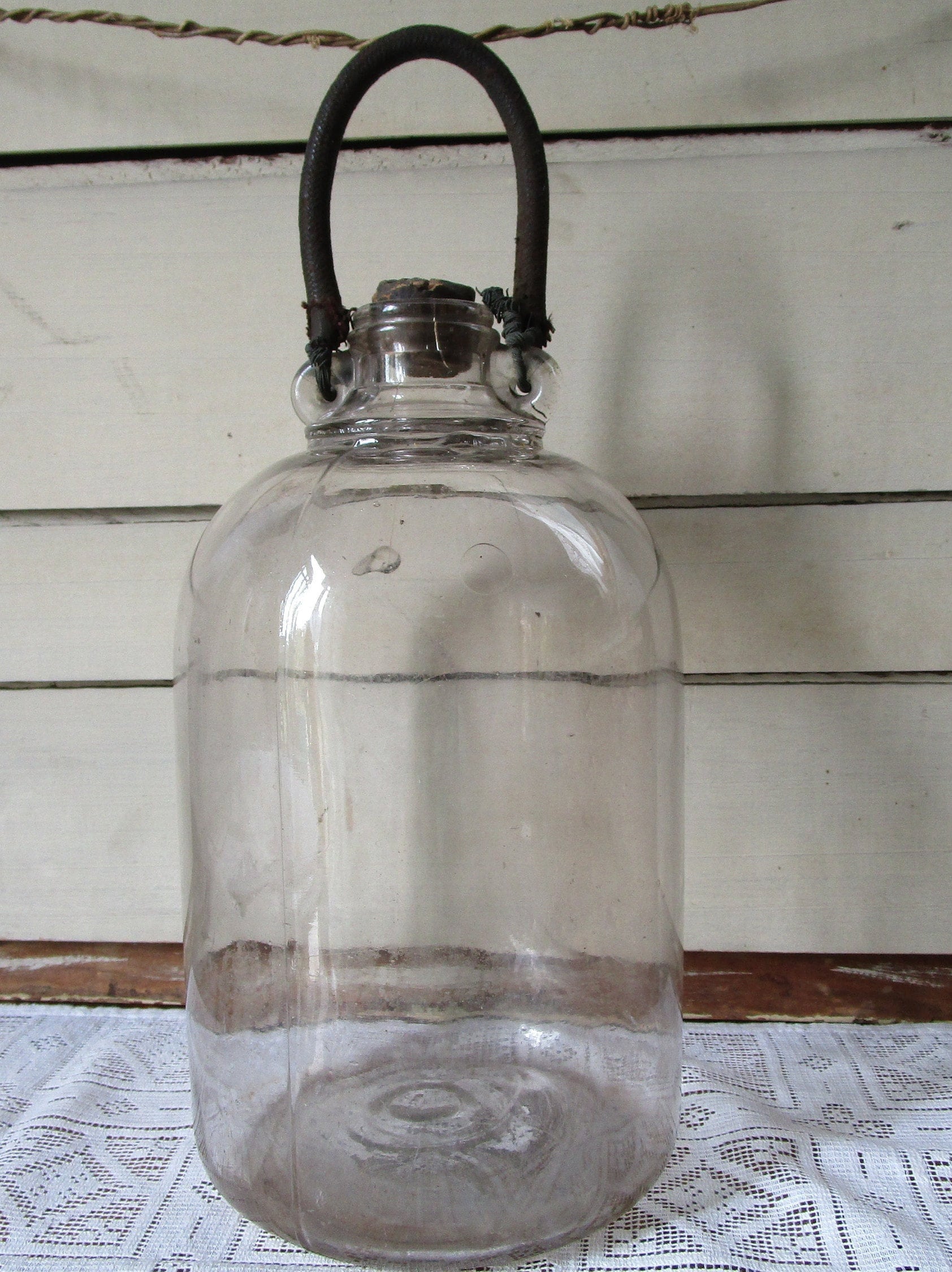 Antique gallon jug w leather wrapped wire handle and cork. Etsy