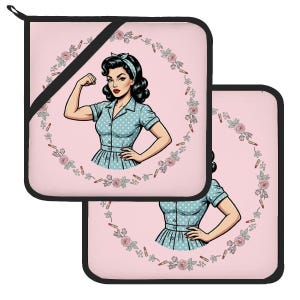 May include: Two square pot holders with a light pink background and black trim. The center features a retro-style illustration of a person with dark hair wearing a blue polka dot dress, flexing one arm, surrounded by a circular wreath of pink roses and lipsticks.