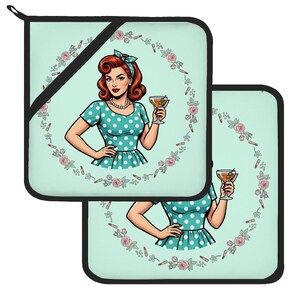 May include: Two square pot holders with a light mint green background featuring a retro illustration of a person with red hair wearing a blue polka dot dress and a matching headband, holding a martini glass, surrounded by a wreath of pink roses.