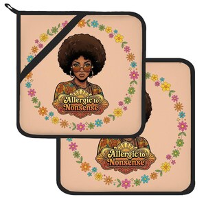 May include: Two square pot holders with a light peach background, featuring a central illustration of a person with an afro hairstyle and sunglasses, surrounded by a circular floral wreath and the text Allergic to NONSENSE in a stylised font.