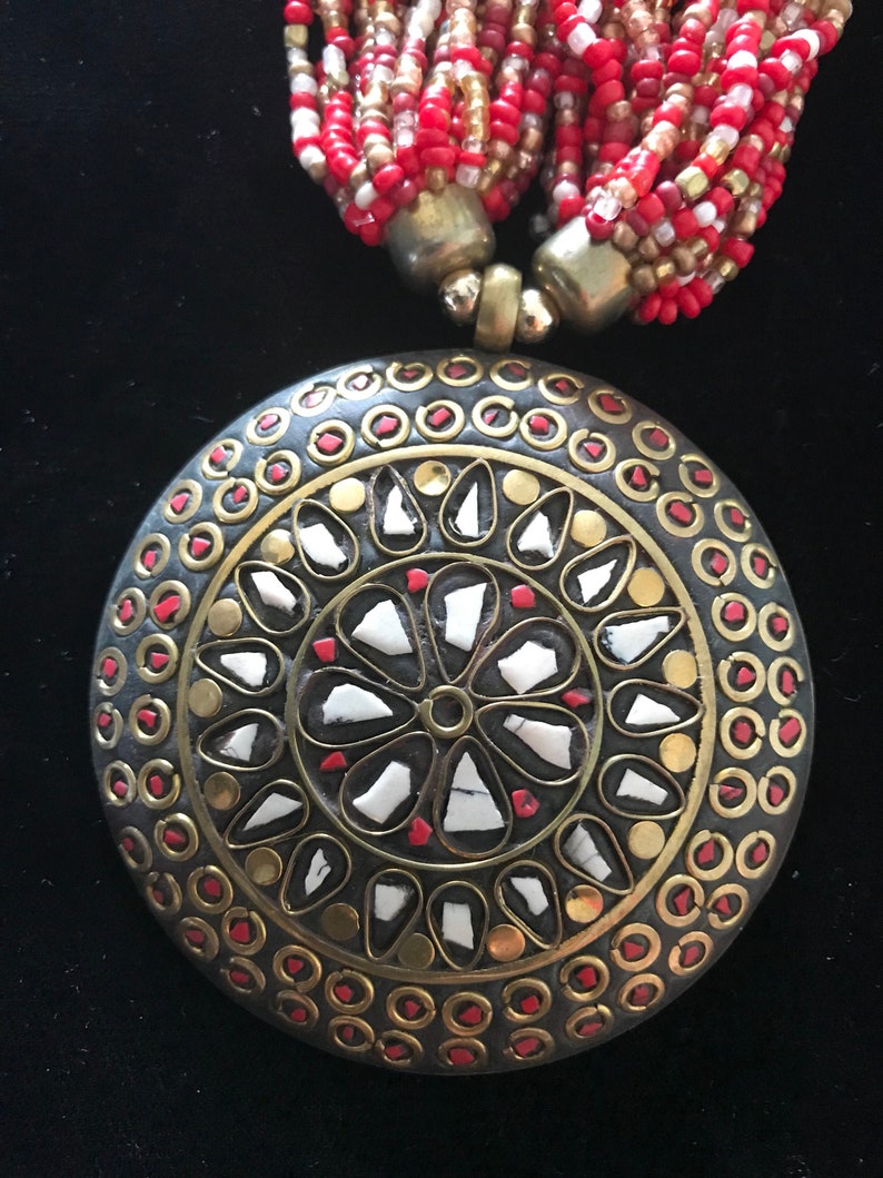 Multistrand necklace with pendant and earrings