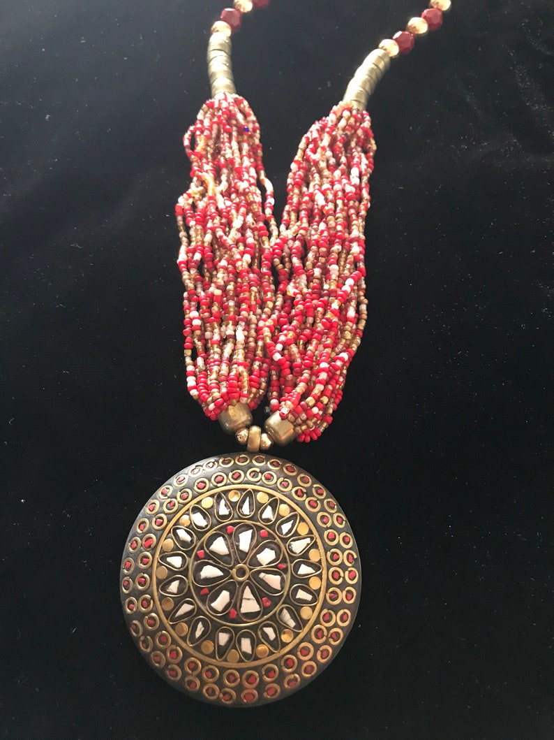 Multistrand necklace with pendant and earrings
