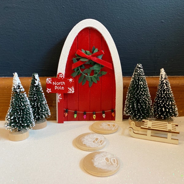 Handmade red Christmas fairy and elf doors with wreath and personalised sign post in red