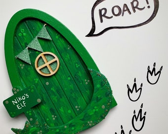 Hand painted green dinosaur door with hand painted scales, personalised sign post and wooden tail.