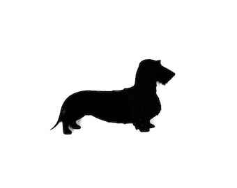 May include: Silhouette of a black dachshund dog standing on a white background.