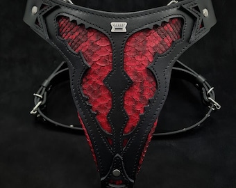 May include: Black leather harness with a red snakeskin pattern and silver accents. The harness features a decorative crown design in the centre.