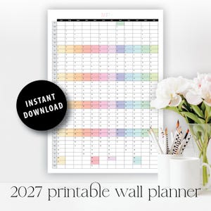 May include: A 2027 wall planner calendar featuring a vertical grid layout with months across the top and days listed down the side. The grid includes pastel-colored blocks for specific dates. A black circular badge displays the text INSTANT DOWNLOAD.