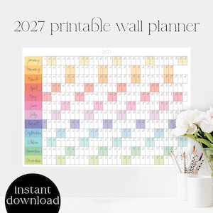 May include: A 2027 printable wall planner featuring a horizontal grid layout with twelve rows representing each month. Each month is color-coded with a unique pastel shade and includes numbered days and abbreviated days of the week in black text.
