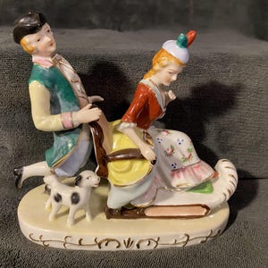Vintage Occupied Japan Porcelain Figurine Man pushing Woman on a Sleigh