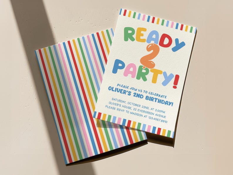 May include: Two birthday party invitations. One invitation features the text "READY 2 PARTY!" in colorful bubble letters. The invitation also includes the text "PLEASE JOIN US TO CELEBRATE OLIVER'S 2ND BIRTHDAY!" The other invitation has a striped pattern.