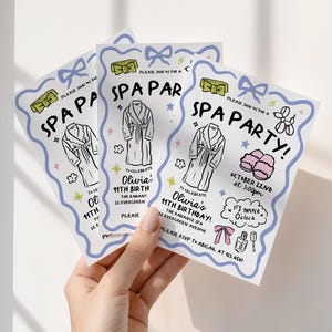 May include: Spa party invitations with a light blue border, featuring illustrations of spa robes, slippers, and bows. The text reads "Spa Party!" and includes details for Olivia's 11th birthday at The Radiance Spa.
